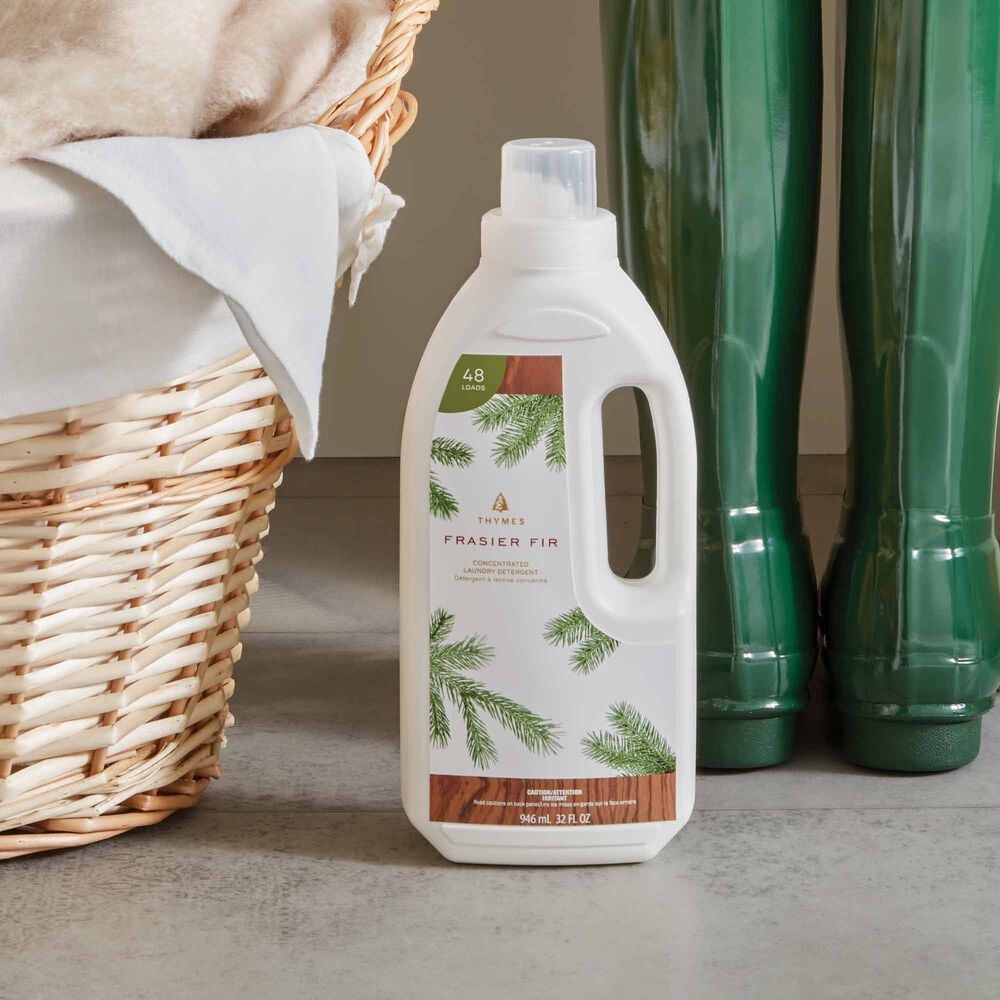 Thymes Frasier Fir Concentrated Laundry Detergent Next to Basket image number 3